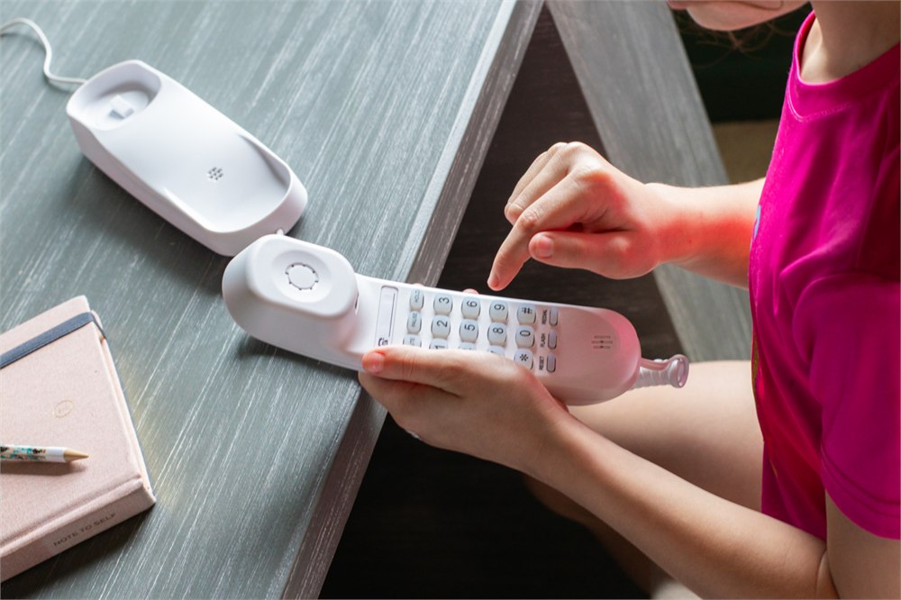 Child dialing the Pinwheel Home screen-free Wi-Fi phone