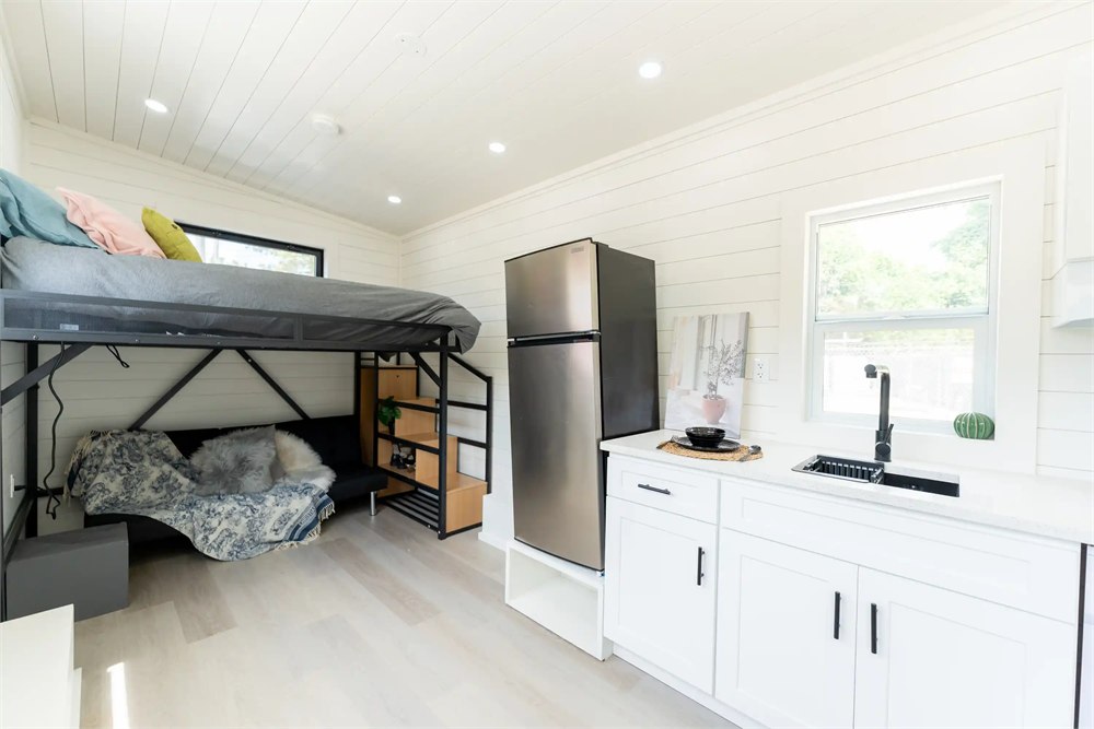 The Fairfax 20 kitchen with cabinetry, sink, cooktop, and compact appliances