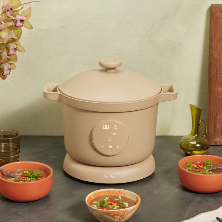 Beige Our Place Dream Cooker on a counter with soup bowls