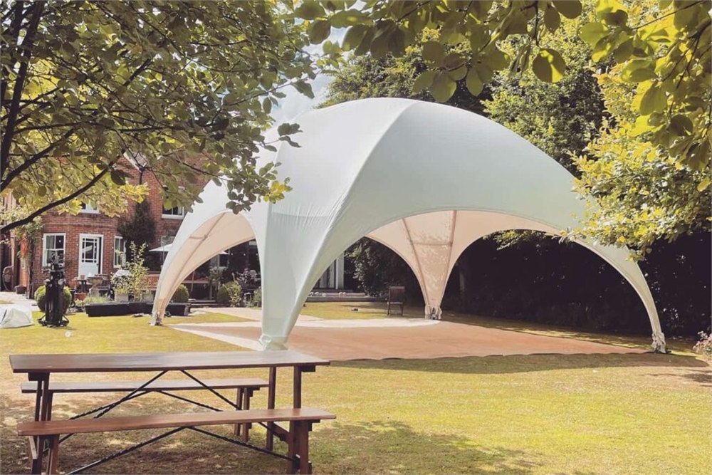 DreamDomes Crossover L dome arranged for an outdoor garden event
