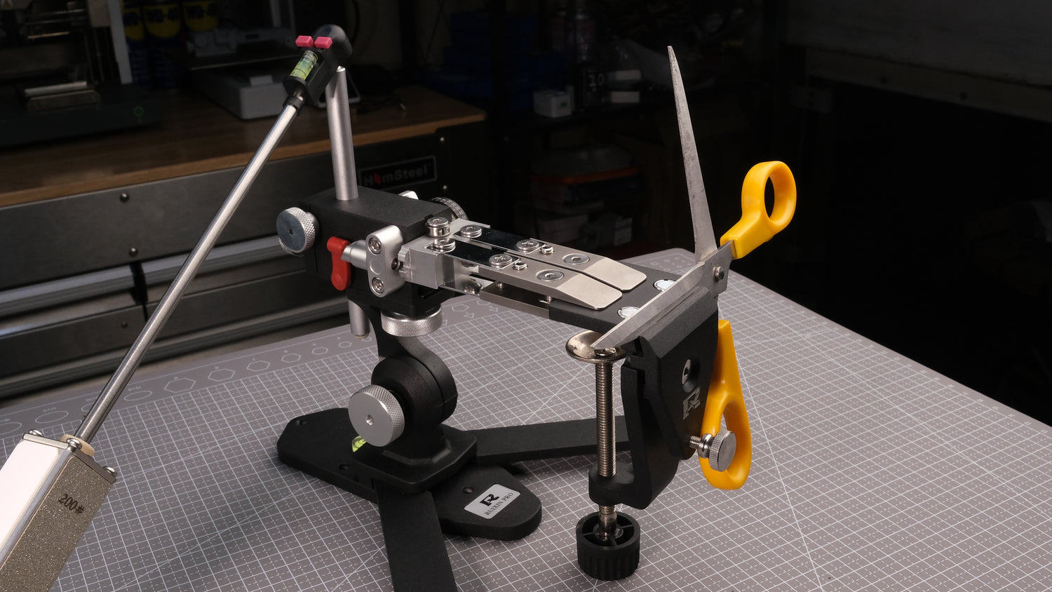 Ruixin Pro Omnix guided sharpener holding a knife blade