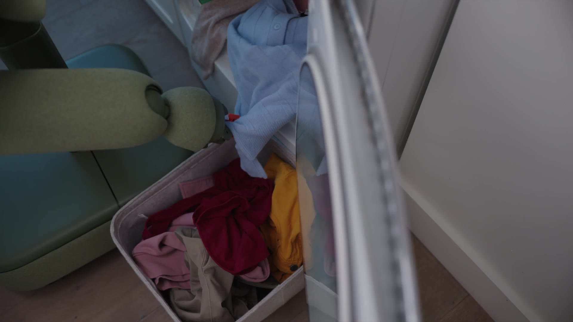 Isaac 1 home robot handling a basket of laundry