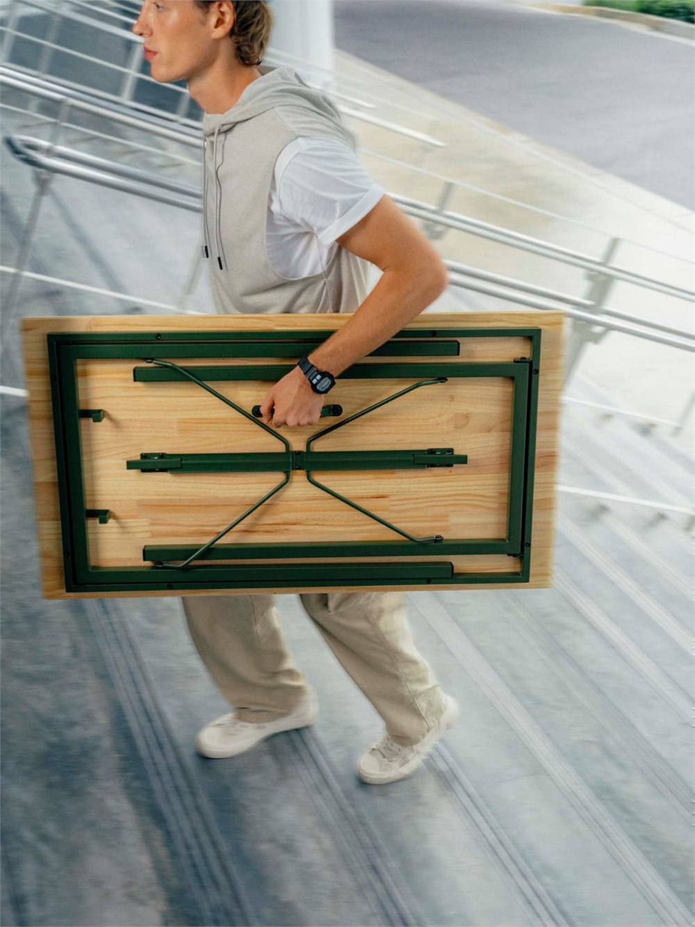 IKEA KOMPISHANG folding desk carried by its built-in handle.