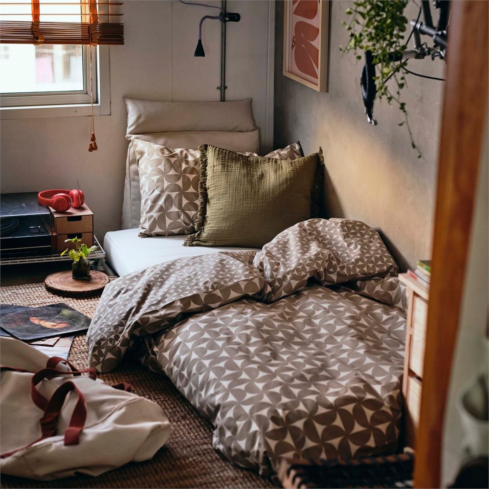 IKEA KOMPISHANG cushion and bedding setup turning a bed into a lounge.
