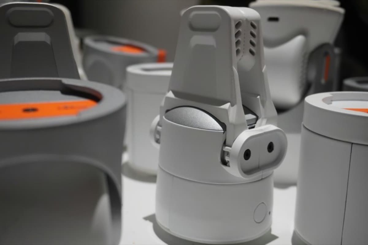 Kynooe One white robotic gripper module mounted on a cylindrical base