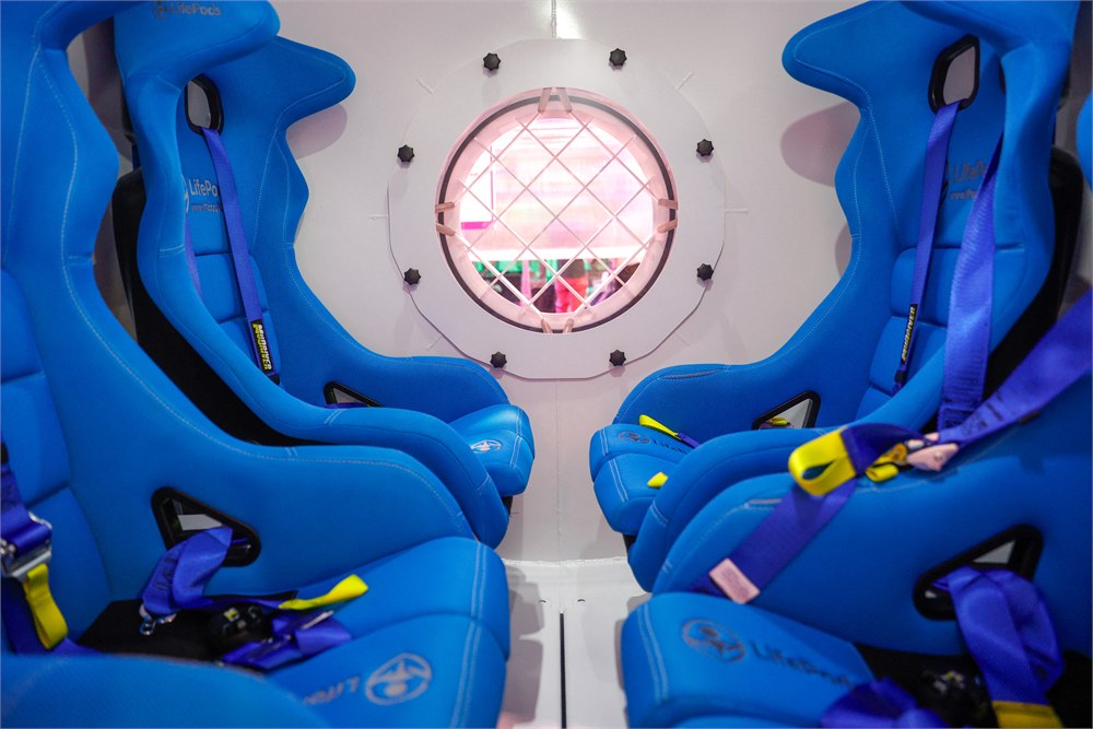 Interior of the LifePods W01 with blue anti-shock bucket seats and harnesses