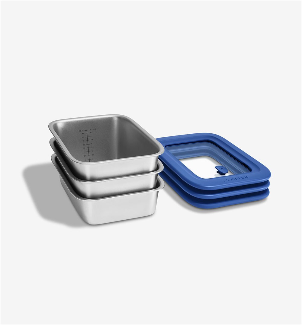 Stacked Misenware stainless steel food containers with blue universal lids