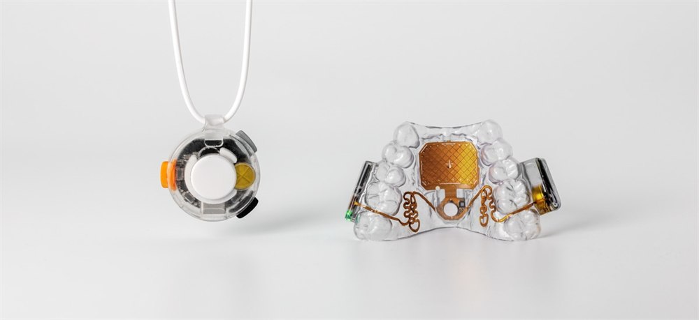 Augmental MouthPad shown beside the VOX wearable microphone