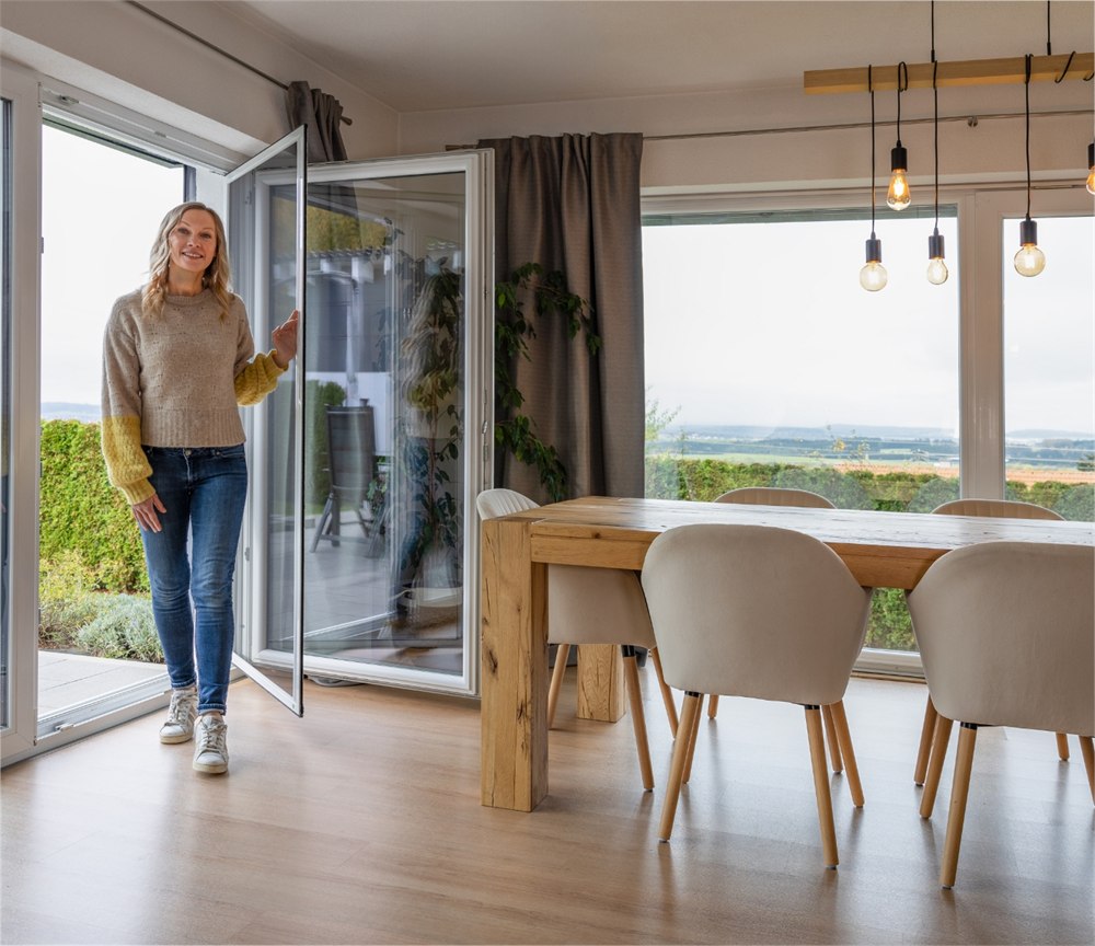 Neher self-closing swing screen door open at a patio entrance