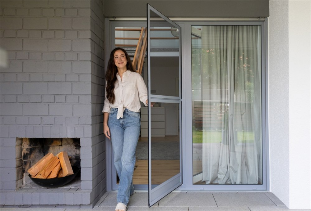 Neher insect screen swing door with a center sash bar at a terrace door