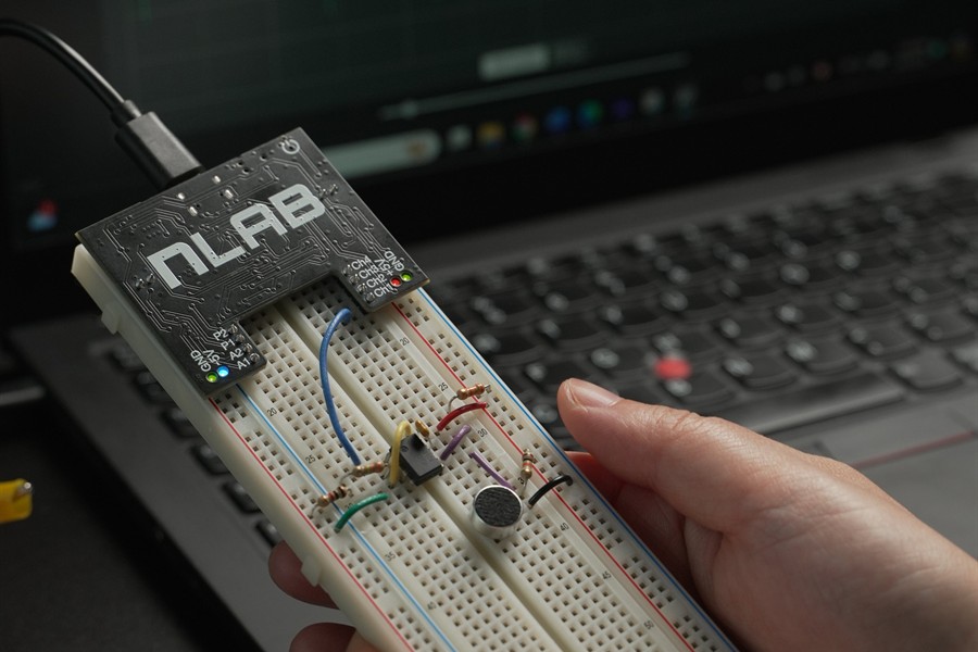 Closeup of the black nLab module on a solderless breadboard