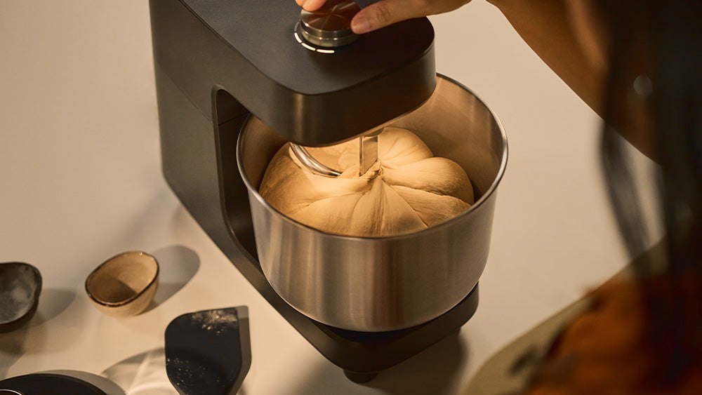 Ooni Halo Core compact spiral mixer kneading pizza dough in its stainless bowl
