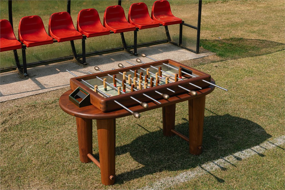 Orior marble foosball table with walnut frame on a football pitch