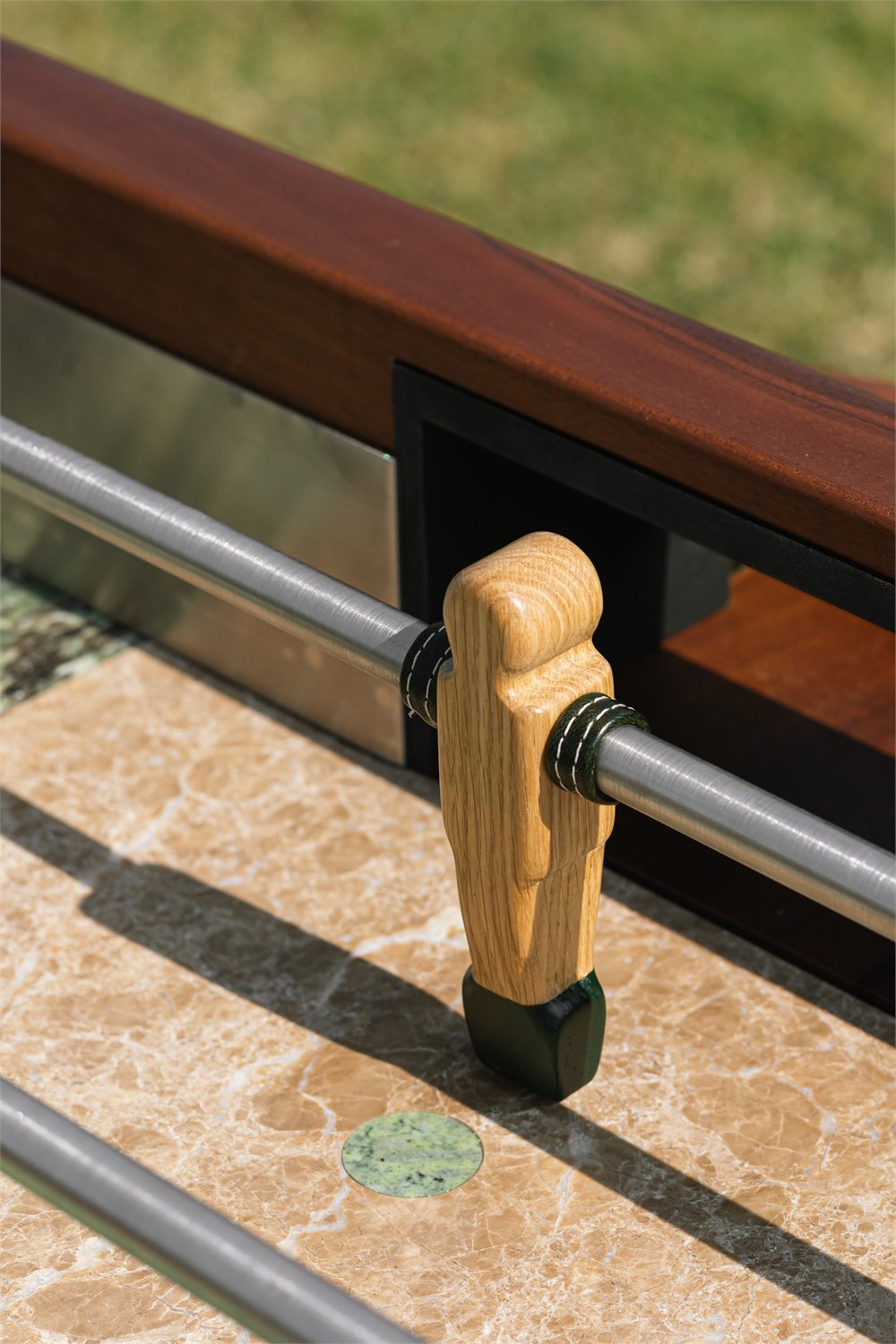 Orior Foosball Table detail showing hand-painted wooden player and marble playing surface
