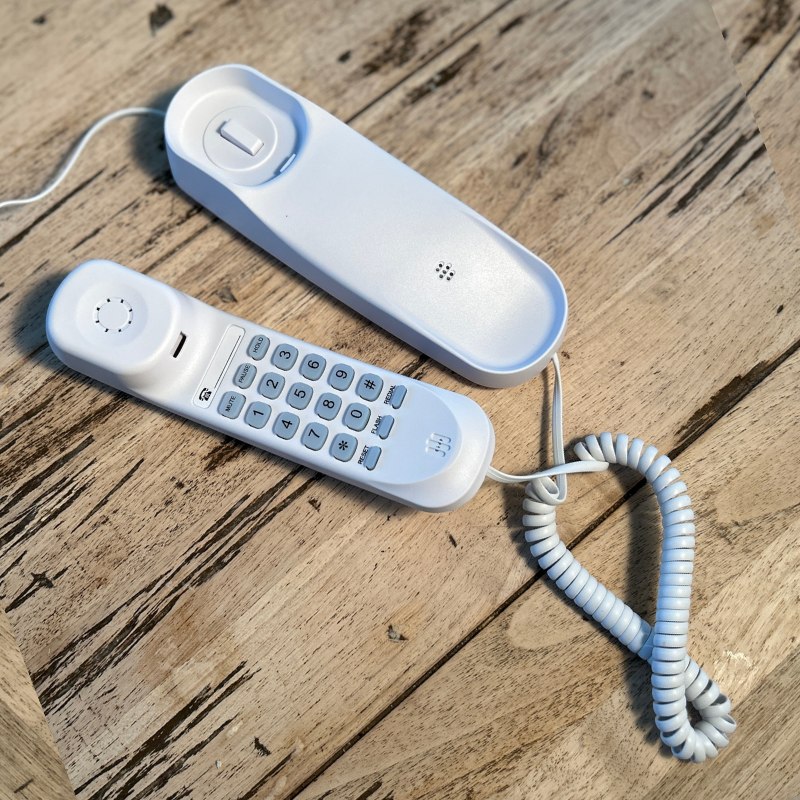 Pinwheel Home handset and charging base shown open on a tabletop