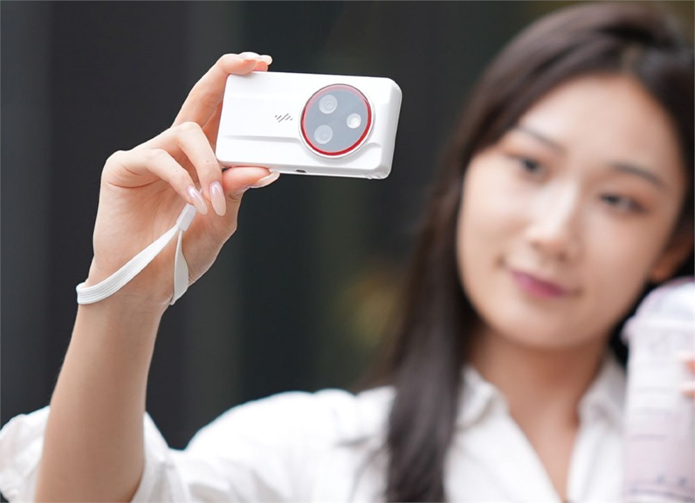 PocketTrio 4K triple-lens touchscreen camera held up in one hand