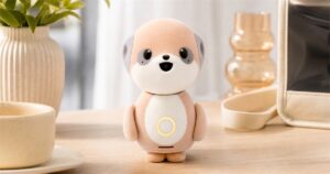 Poketomo pocket AI companion robot on a warm tabletop