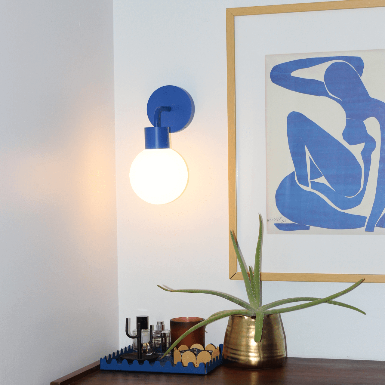 Blue Poplight stick-on wall light above a dresser