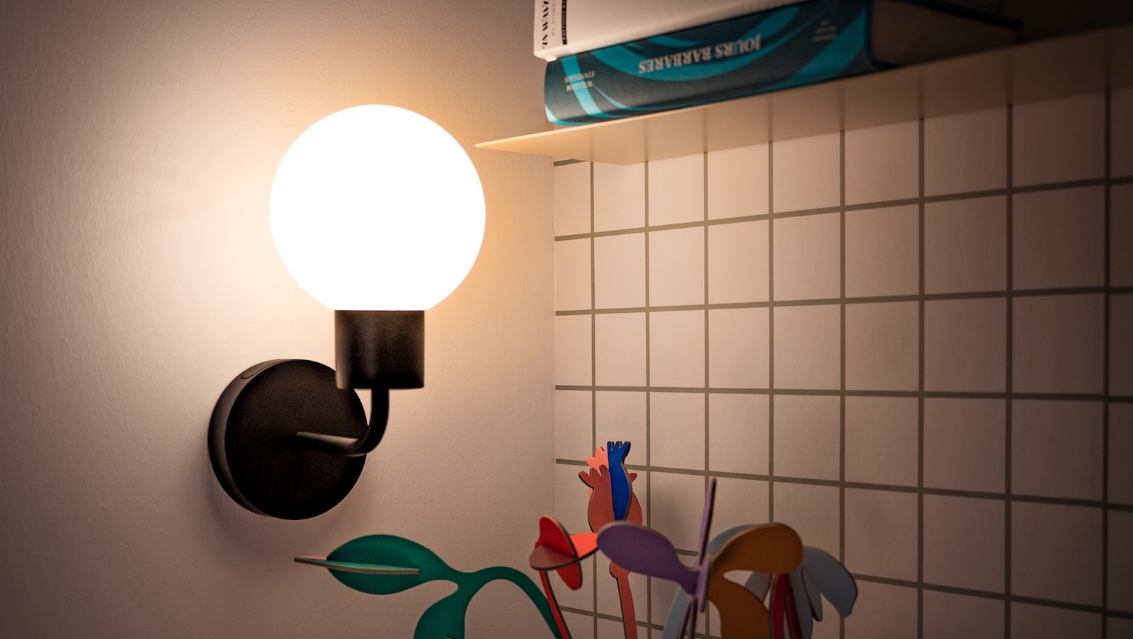 Poplight stick-on wall sconce mounted on a wall