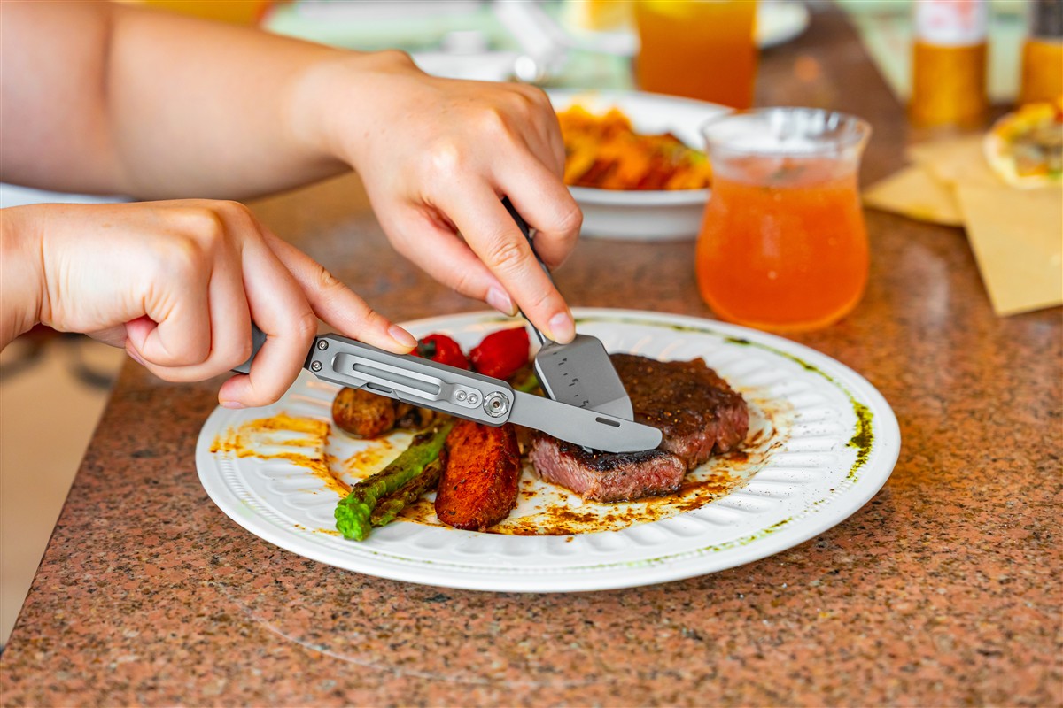 The FieldSpork titanium multitool showing its fold-out steak knife and compact utensil design