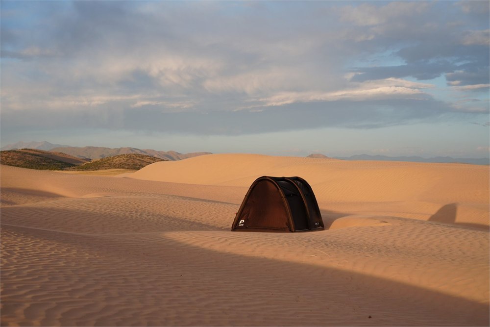 White Puffer inflatable tent set up on sand dunes