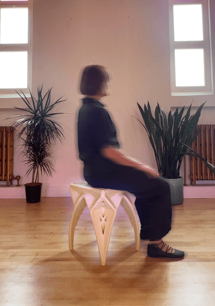 Person sitting on the QWRKhouse CAVITY 3D-printed stool