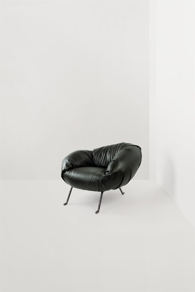 Faye Toogood Soft Slump armchair with dark gathered upholstery on metal legs
