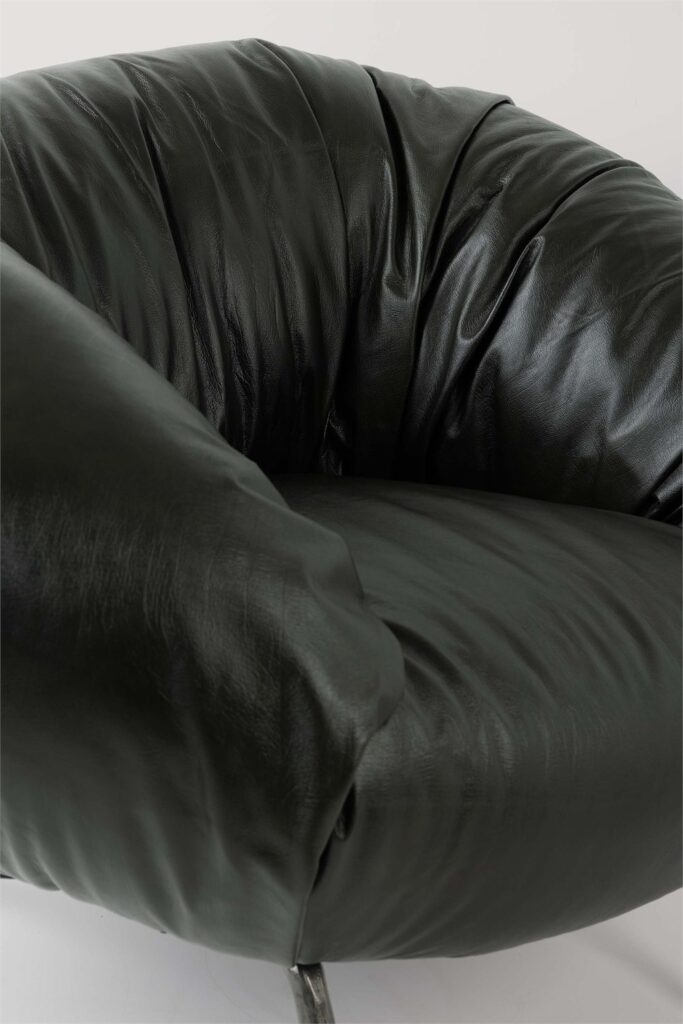 Close-up product detail of the dark Soft Slump armchair upholstery and construction