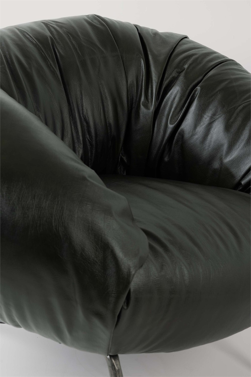 Close-up product detail of the dark Soft Slump armchair upholstery and construction