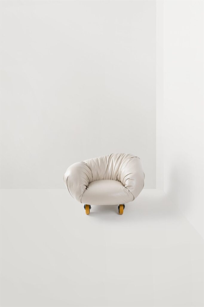 Cream Soft Slump armchair on industrial wheels from the official product page