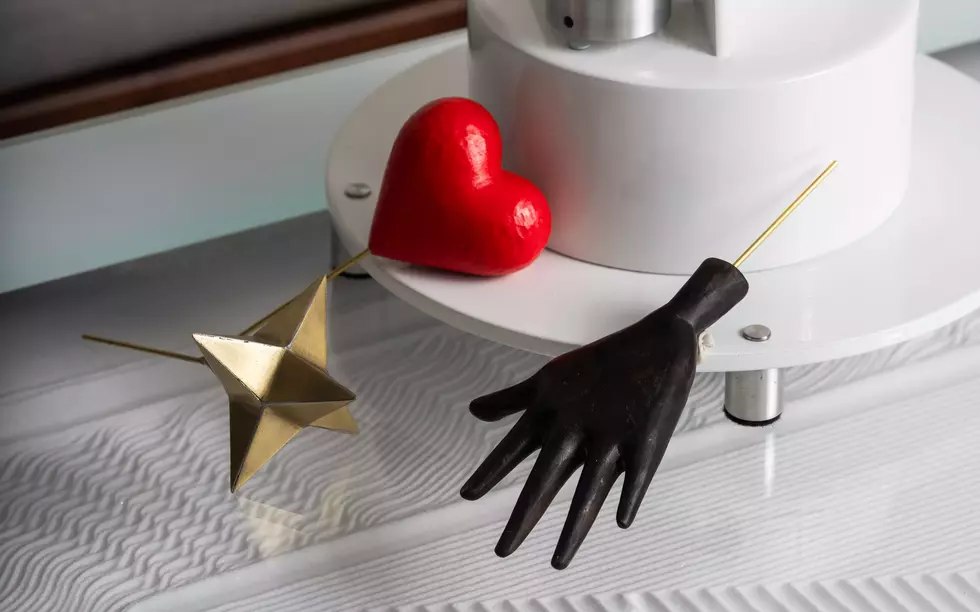 Detail view of the Solar Orbiter heart, hand, and star decorative elements near the base