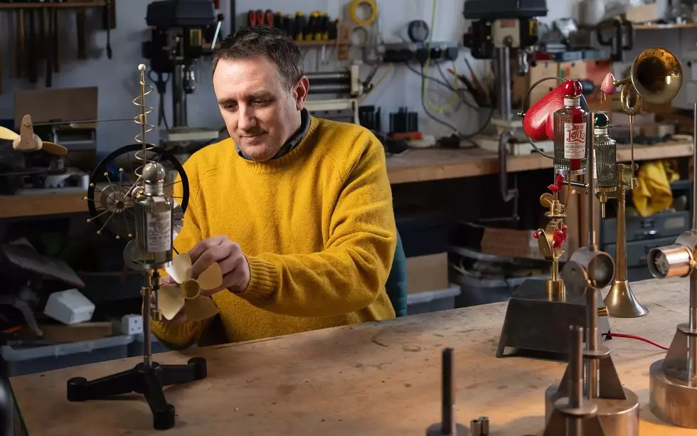 Martin Smith assembling kinetic artwork in a studio workshop