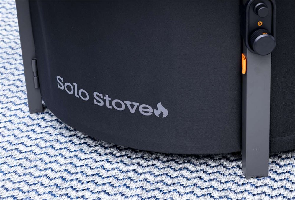 People gathered around the Solo Stove Infinity Flame on a patio at night