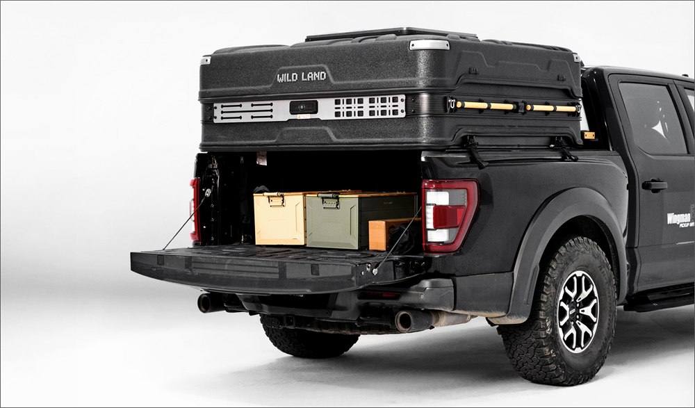 Wingman camper mounted to a pickup truck with the rear basecamp area open