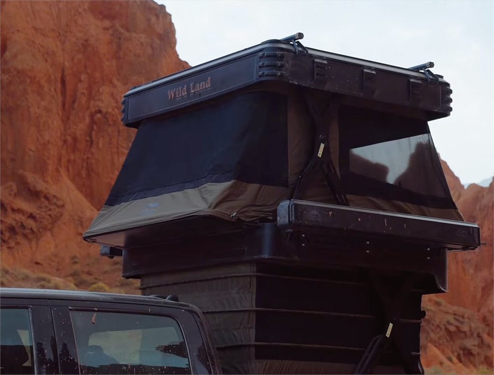 Wingman pickup camper raised into its tall two-level campsite form
