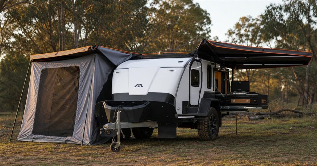 Stockman Rover dual-wing teardrop camper opened at a campsite