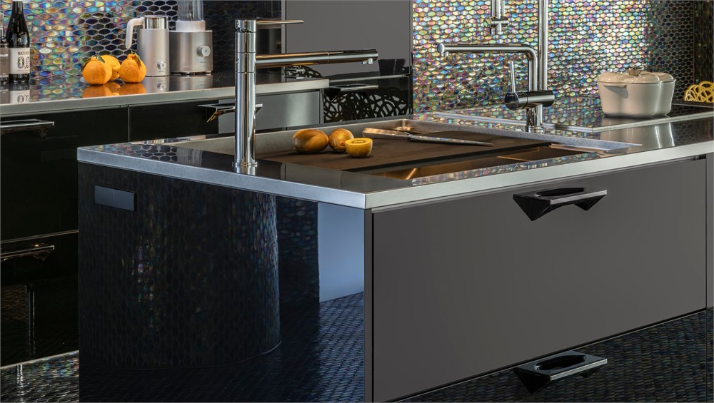 Close view of the CORE kitchen sink work zone with stainless top and dark cabinet fronts