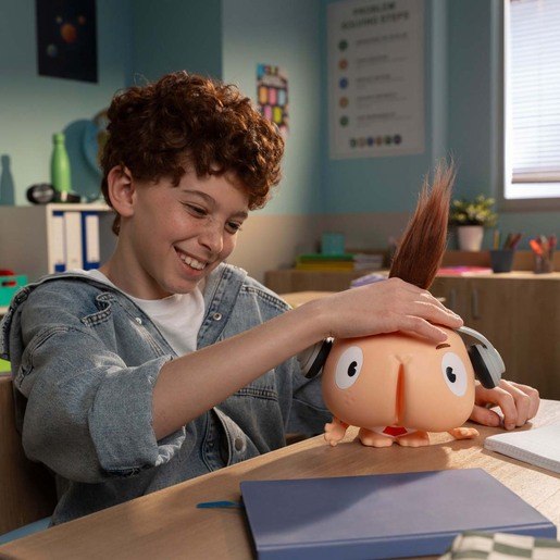 Child playing with Chester Cheeks Butt Face toy at a desk