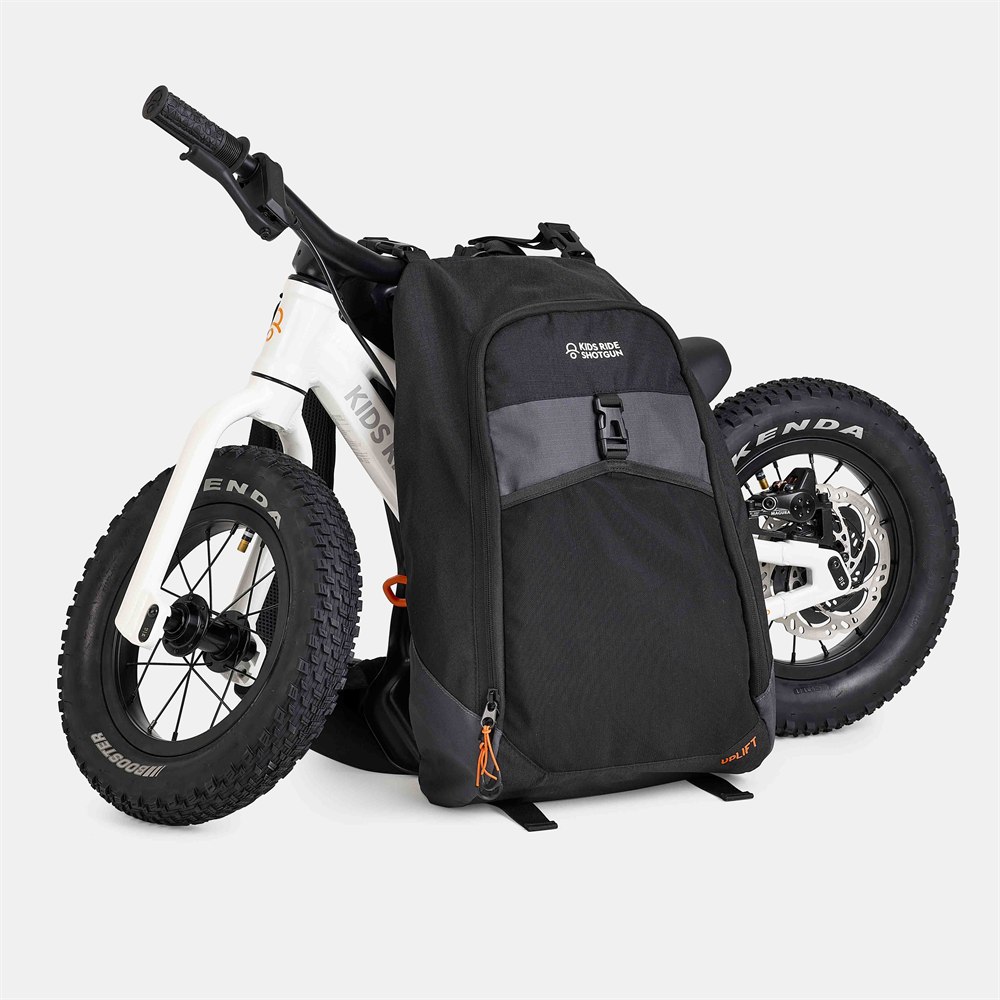 Kids Ride Shotgun Uplift balance bike carrying backpack with a white balance bike mounted behind it
