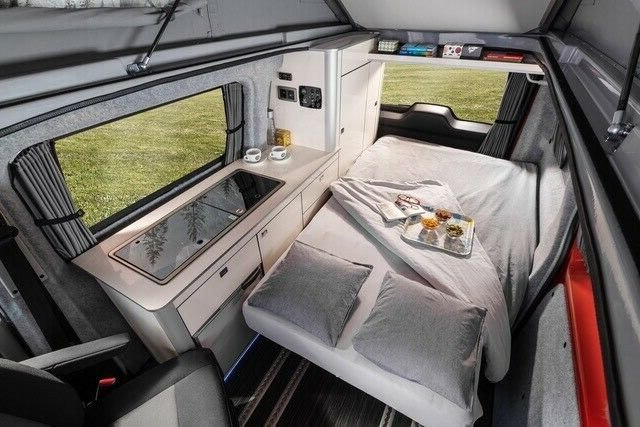 Wellhouse side camper conversion layout with bed and compact kitchen area