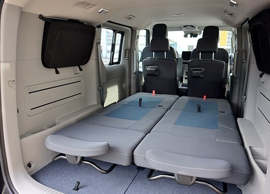 Removable sliding campervan seats folded down into a bed layout