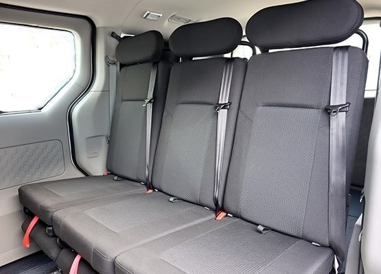Removable campervan seat shown upright on a sliding rail system