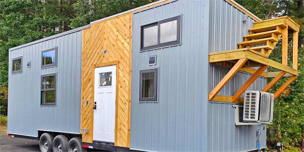 Gray and cedar White Pine tiny house exterior on a triple axle trailer
