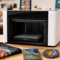 xTool O1 Omni multi-material printer with colorful printed sample objects