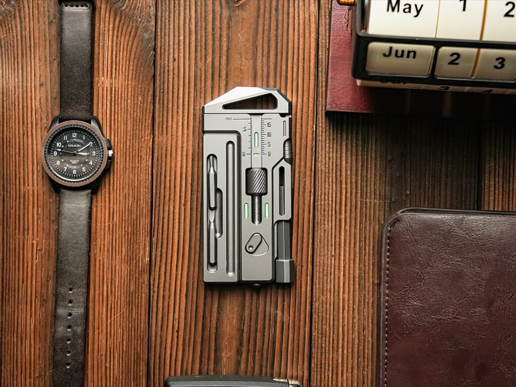 Front and back views of the titanium multitool wrench on a wood surface