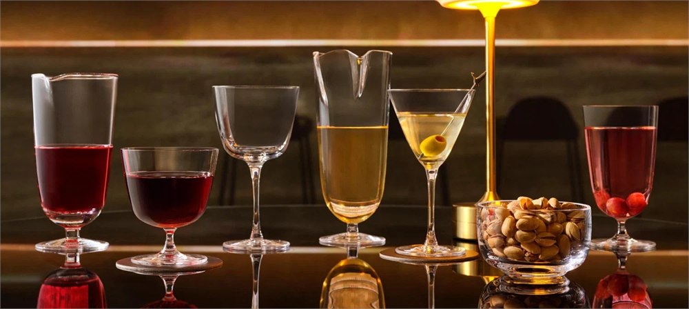 Bar/Giani glassware collection on a warmly lit bar