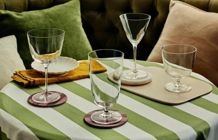 Bar/Giani glasses arranged on a green striped table