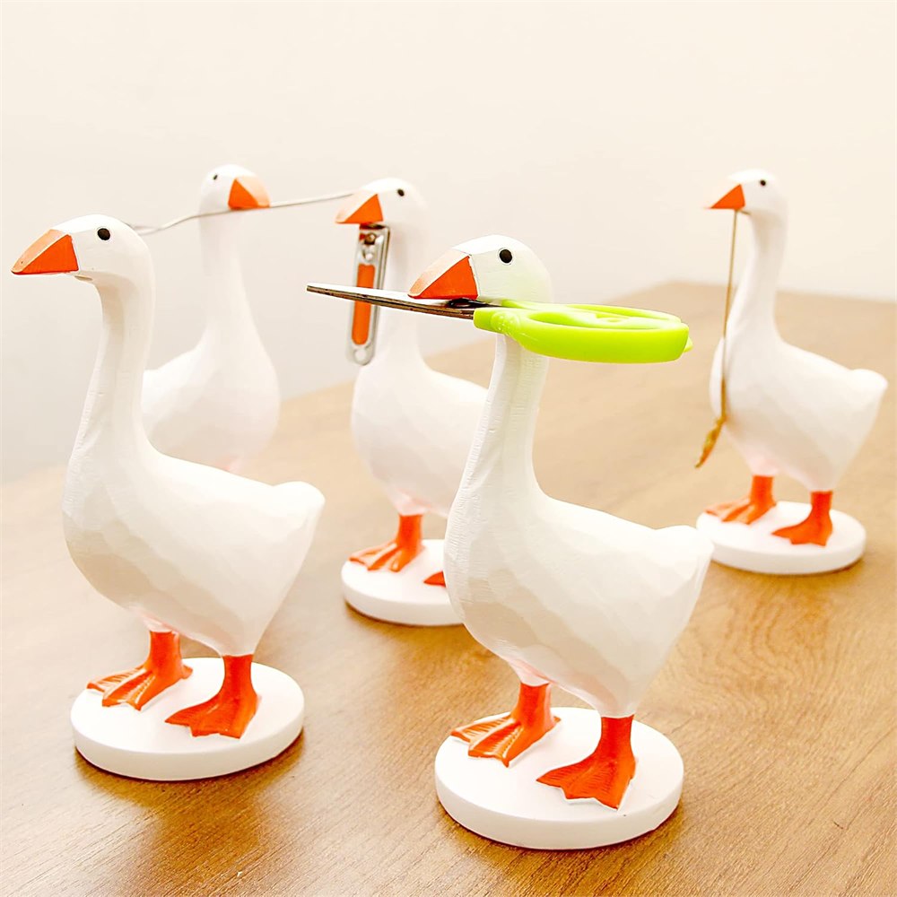 Several magnetic goose key holders gripping scissors and small metal accessories