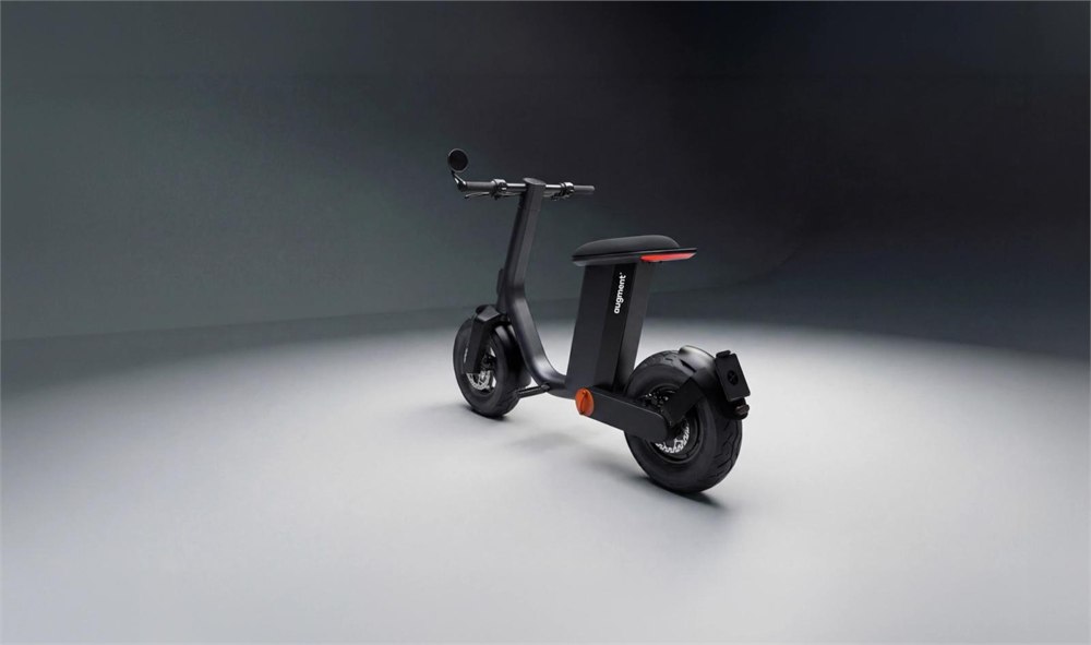 Augment 360 folding electric moped being ridden in a city setting