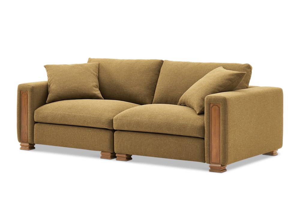 Angled view of the Kagan 3 Seater Sofa showing the deep cushions and oak pillar arm detail